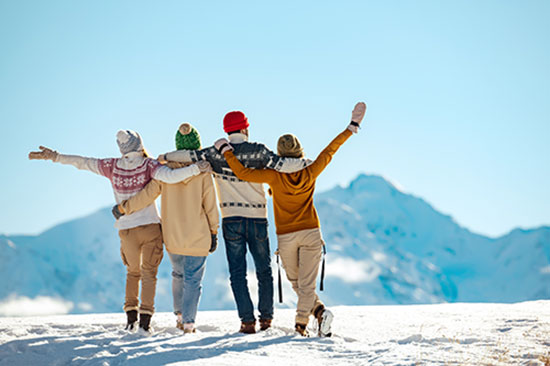 Family looking out over mountains in the snow.