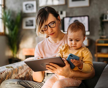 A mom and child using a tablet at home.