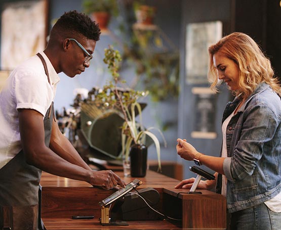 Woman using watch to make a payment at the store