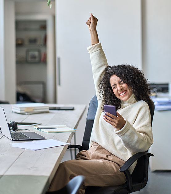 Woman smiling and raising her hand.