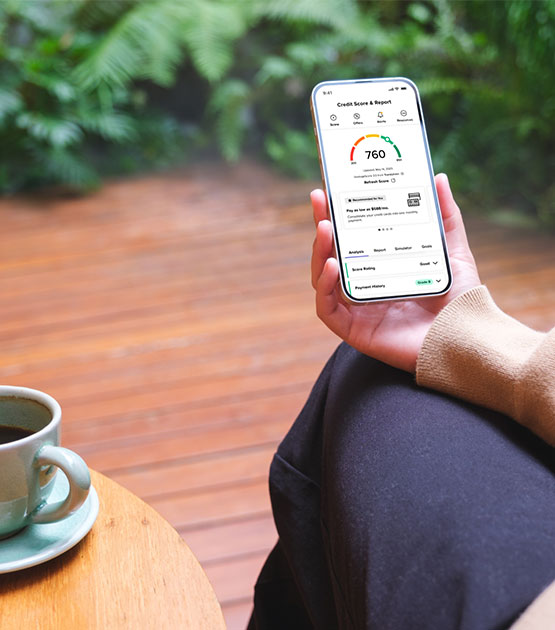 Person holding the phone looking at Savvymoney credit score.